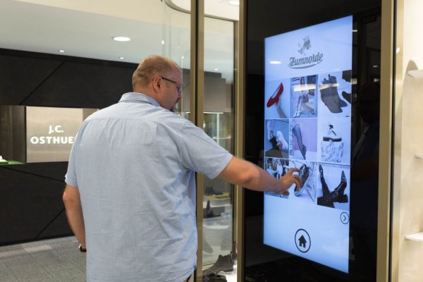 A person operates a screen in the brick-and-mortar store